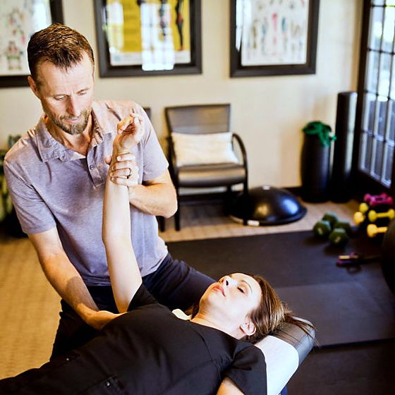 A practitioner treating a patient on a table