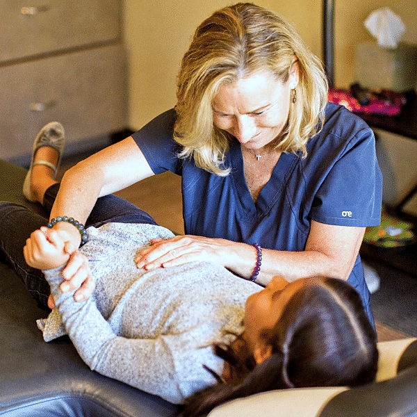 A chiropractor in Costa Mesa treating a patient